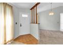 Entryway with hardwood floors, a half wall, and a chandelier at 4750 Carrington Ct, New Port Richey, FL 34655