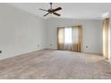 Spacious living room with wall-to-wall carpet and ceiling fan at 4750 Carrington Ct, New Port Richey, FL 34655
