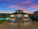 Two story waterfront home with attached two car garage at dusk at 3448 Triggerfish Dr, Hernando Beach, FL 34607