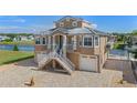 Two story waterfront home with attached two car garage and paver driveway at 3448 Triggerfish Dr, Hernando Beach, FL 34607