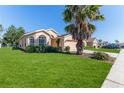 Single-story house with a palm tree and well-maintained lawn at 1183 Mystic Ct, Spring Hill, FL 34609