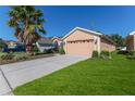 House exterior with driveway and palm tree at 1183 Mystic Ct, Spring Hill, FL 34609