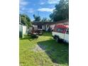 House exterior with a cluttered backyard and a pickup truck at 3310 68Th N Ave, St Petersburg, FL 33702
