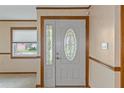 Front entry with white door and stained glass accents at 7208 Clouchester Ct, Hudson, FL 34667
