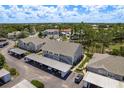 Aerial view of the condo community featuring well-maintained buildings, carports and lush landscaping at 7712 Hillside Ct # 202, Hudson, FL 34667