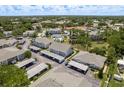 Wide aerial view showcasing the condo community, pool, landscaping, and surrounding neighborhood at 7712 Hillside Ct # 202, Hudson, FL 34667
