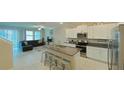 Open concept kitchen with island, living room and stairs at 31941 Blue Passing Loop, Wesley Chapel, FL 33545