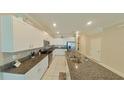 Modern kitchen with granite countertops and stainless steel appliances at 31941 Blue Passing Loop, Wesley Chapel, FL 33545