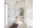 Bright entryway with tile flooring and view into living area at 1005 Indigo Run Ct, Spring Hill, FL 34609