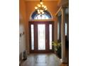 Bright entryway with hardwood floors and decorative chandelier at 11033 Baywind Ct, Weeki Wachee, FL 34613
