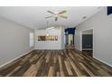 Spacious living room with dark hardwood floors and a ceiling fan at 1633 Arbor Knoll Loop, Trinity, FL 34655