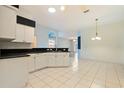 Kitchen features a breakfast nook and views into the living room at 12200 Putter Green Ct, New Port Richey, FL 34654