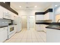 Bright kitchen with white cabinets and black countertops at 12200 Putter Green Ct, New Port Richey, FL 34654
