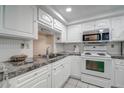 Cozy kitchen with white cabinets and granite countertops at 4129 Stratford Dr # 4129, New Port Richey, FL 34652
