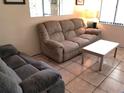 Living room featuring tile floors, cozy seating and natural light at 20861 Haulover Cv # C4, Lutz, FL 33558
