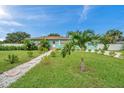 Well maintained lawn, stone path leading to light teal home at 800 61St N St, St Petersburg, FL 33710