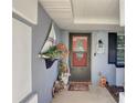 Home's entrance with decorative nautical accents and a welcoming doormat at 3960 Lema Dr, Spring Hill, FL 34609