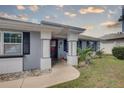 Inviting home exterior featuring a charming front porch and well-maintained landscaping at 3960 Lema Dr, Spring Hill, FL 34609