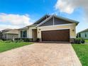 House exterior with a brown garage door and blue shutters at 19492 Fort King Run, Brooksville, FL 34601