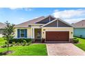 House exterior with a brown garage door and blue shutters at 19492 Fort King Run, Brooksville, FL 34601