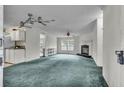 Spacious living room with fireplace and teal carpet at 9520 Merton St, New Port Richey, FL 34654