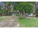 Single-wide mobile home with covered porch and a large yard at 9520 Merton St, New Port Richey, FL 34654