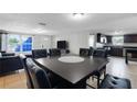 Open dining area with dark wood table and leather chairs at 7446 Donegal St, New Port Richey, FL 34653
