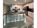 Modern kitchen with granite countertops, stainless steel appliances, and an island at 15434 Miller Creek Dr, Sun City Center, FL 33573