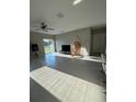 Bright living room featuring tile floors and sliding glass doors at 15434 Miller Creek Dr, Sun City Center, FL 33573
