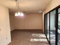 Bright living room with carpet and sliding doors at 6592 Brambleleaf Dr, Spring Hill, FL 34606