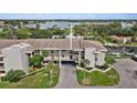 Stunning aerial view of waterfront condo complex with lush landscaping and convenient covered parking at 8210 Aquila St # 227, Port Richey, FL 34668