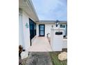 Front entrance of the home with a walkway and landscaping at 8141 Bugle Ct # 1, Port Richey, FL 34668