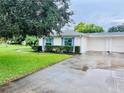 View of the home's exterior, including the garage and landscaping at 8141 Bugle Ct # 1, Port Richey, FL 34668