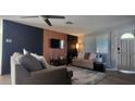Bright living room with modern wall decor and comfy seating at 3814 Holiday Lake Dr, Holiday, FL 34691
