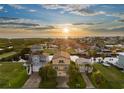 Stunning sunset aerial view of waterfront homes, showcasing canals and coastal living in this beautiful neighborhood at 4109 Des Prez Ct, Hernando Beach, FL 34607