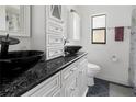 Modern bathroom featuring a granite countertop vanity and black vessel sink at 7504 Cypress Knee Dr, Hudson, FL 34667
