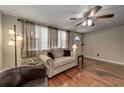 Living room with hardwood floors, couch, and ceiling fan at 6642 Stewart N Ave, St Petersburg, FL 33702