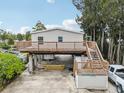 Aerial view of an elevated home with a large deck at 14904 Old Dixie Hwy, Hudson, FL 34667