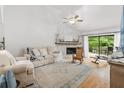 Spacious living room with fireplace and access to a patio at 303 Old Mill Pond Rd # 303, Palm Harbor, FL 34683