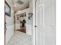 Bright and spacious entryway with tile flooring and views into the kitchen at 13444 Norman Cir, Hudson, FL 34669