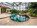 Inviting pool and spa area with screened enclosure at 9943 Milano Dr, Trinity, FL 34655