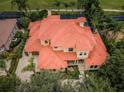 Aerial view of a luxurious home with a red tile roof at 9943 Milano Dr, Trinity, FL 34655