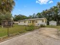 Yellow house with driveway, gazebo and storage shed at 9140 & 9130 Peony St, New Port Richey, FL 34654