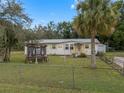 House exterior with a gazebo in a fenced yard at 9140 & 9130 Peony St, New Port Richey, FL 34654