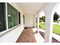 Covered front porch with tile flooring and arched details at 5725 Thrush Dr, New Port Richey, FL 34652