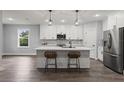 Modern kitchen with white shaker cabinets, quartz countertops, and island at 5406 Boxtree Ct, Dade City, FL 33523