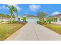 House exterior with a two-car garage and landscaping at 11143 Merganser Way, New Port Richey, FL 34654