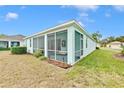Backyard screened porch with paver patio and landscaping at 11143 Merganser Way, New Port Richey, FL 34654