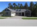 Charming home with a paved driveway, attached garage, manicured lawn and a traditional architectural style at 4676 Hickory Oak Dr, Brooksville, FL 34601