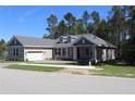 Charming home with a paved driveway, attached garage, manicured lawn and a traditional architectural style at 4676 Hickory Oak Dr, Brooksville, FL 34601